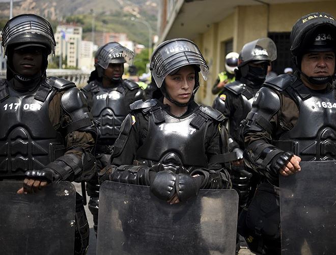 Cảnh sát chống bạo động bảo vệ an ninh trong một cuộc tuần hành ở Cali, Colombia ngày 24-1-2016